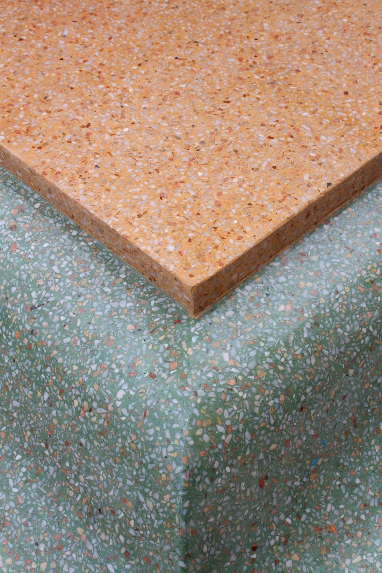 Terrazzo worktop with grey and orange styling
