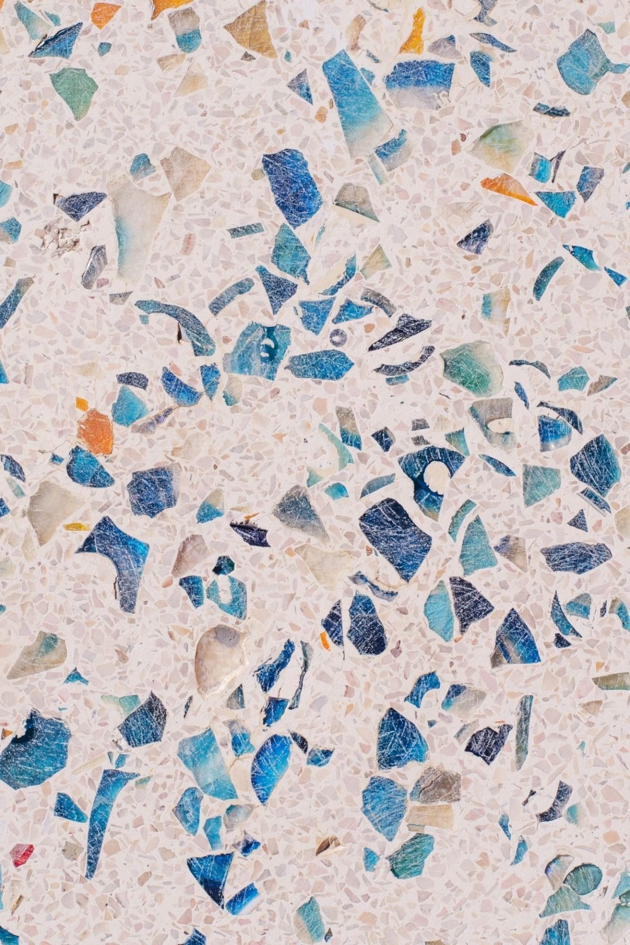 Terrazzo tile with blue, orange and grey fragments